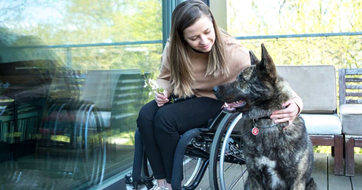 Woman enjoying free time with an assistance dog. (Representative Cover Image Source: Getty Images | Coolpicture)