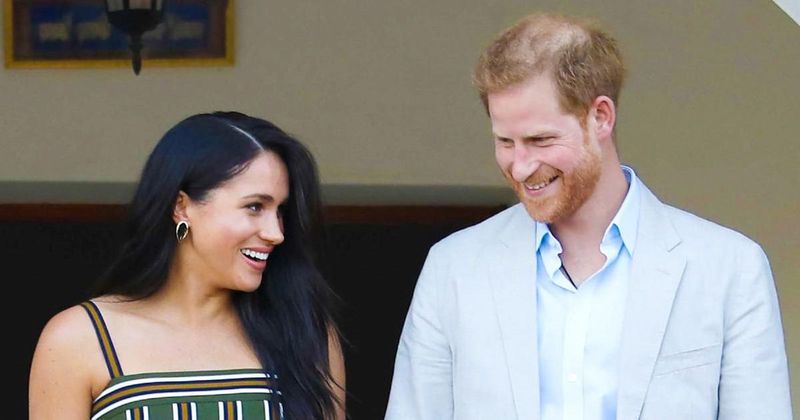 Prince Harry & Meghan Markle Pay Tribute To Pal Elton John At Farewell Concert As They Cozy Up In Sweet Video