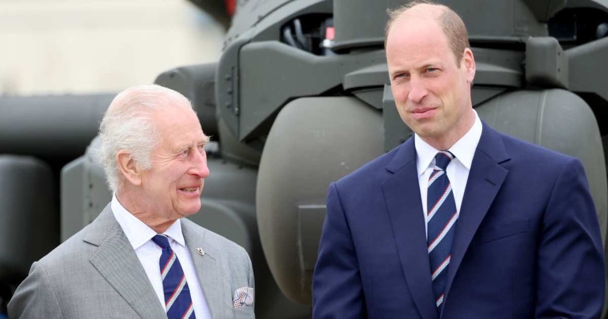 King Charles and Prince William stand in front of an Apache helicopter. (Cover Image Source: Getty Images | Chris Jackson)