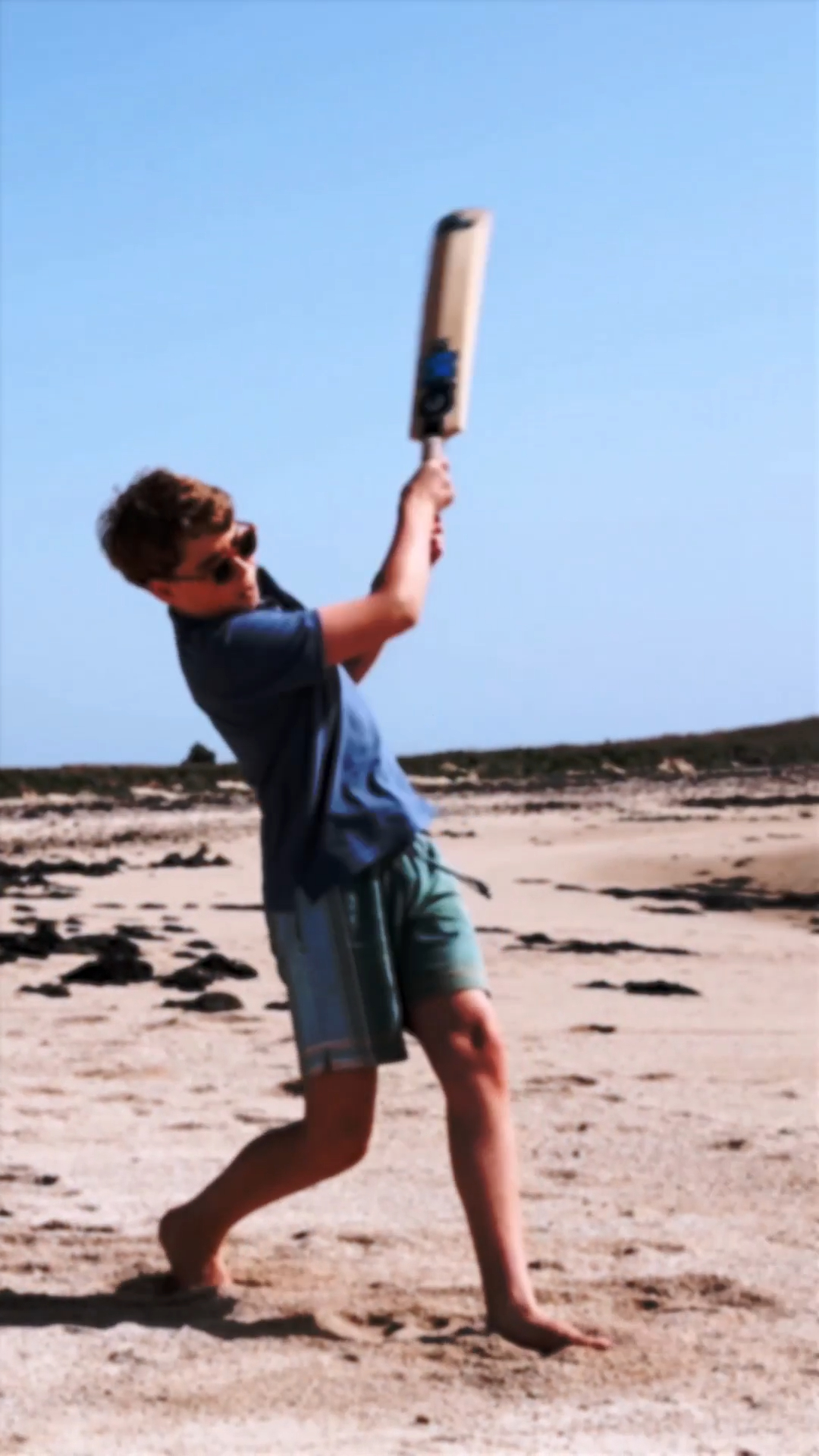 Prince George playing cricket at the beach