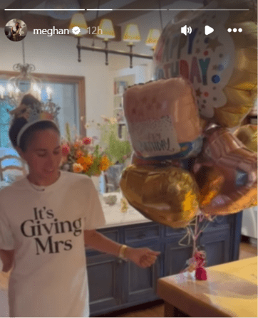 Meghan Markle dancing in her kitchen wearing a birthday tiara and a special T-shirt on her 45th birthday