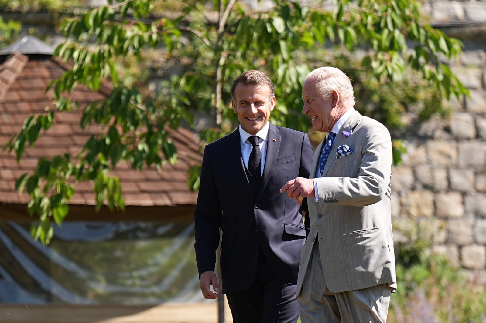 WINDSOR, ENGLAND - JULY 9: King Charles III (R) and the President of France Emmanuel Macron visit the South garden at Windsor Castle Gardens on July 9, 2025 in Windsor, England. President Emmanuel Macron and Mrs Brigitte Macron visit the UK in the first visit State Visit made by France in 17 years. They are staying at Windsor Castle, hosted by King Charles III and Queen Camilla. Today, the Macrons will have lunch with the UK Prime Minister at Downing Street, and a banquet will be held in their honour at The Guildhall. (Photo by Aaron Chown - Pool/Getty Images)