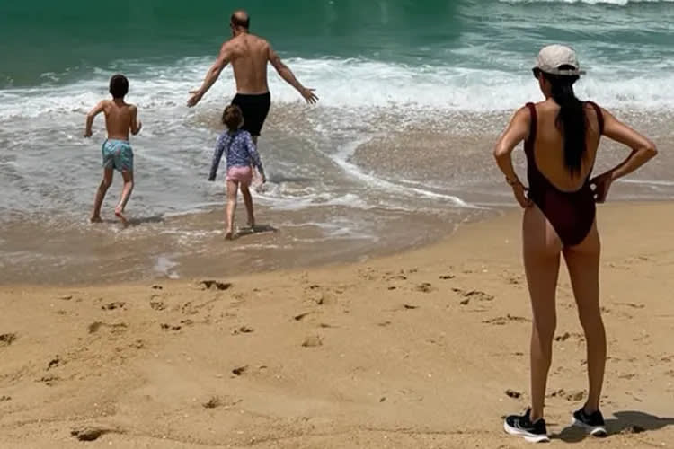 Meghan Markle watches as Prince Harry, Prince Archie, and Princess Lilibet play on the beach. (Image source: Instagram | @meghan.)